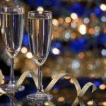 champagne glasses against blue and gold background